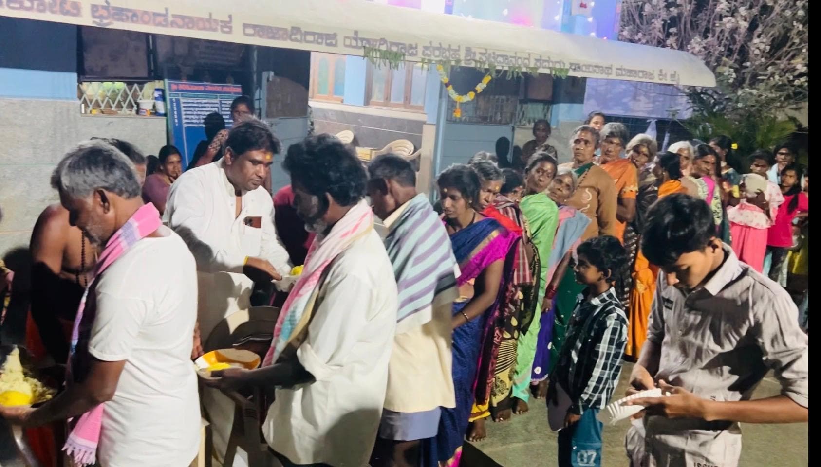 People receiving food from volunteers